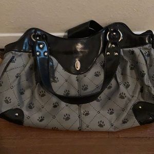 A very nice paw print gray leather purse